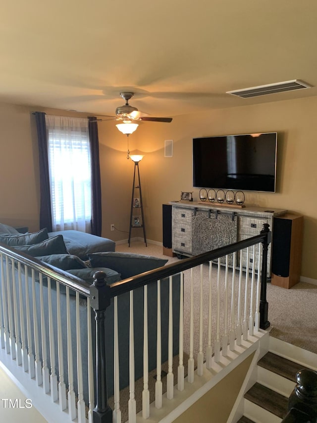 carpeted living room with ceiling fan