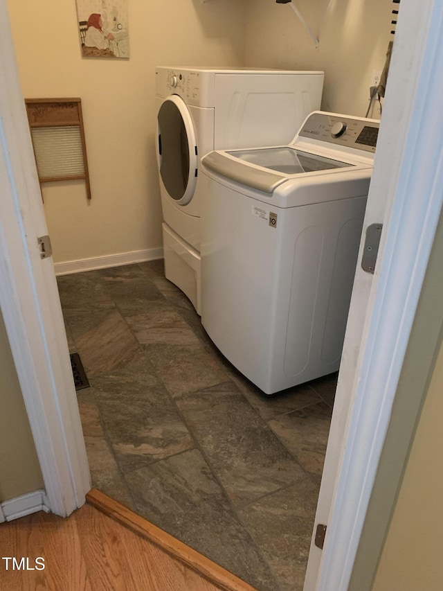 clothes washing area featuring independent washer and dryer