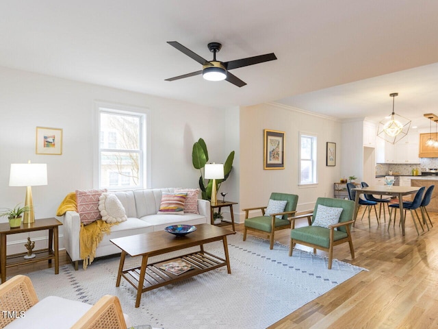 living room featuring ceiling fan and light hardwood / wood-style flooring