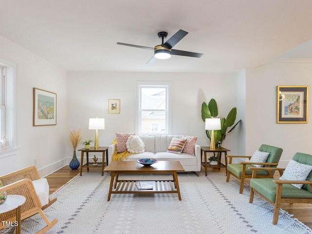 living room with light hardwood / wood-style floors and ceiling fan