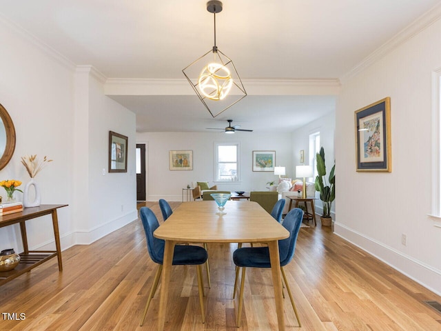 dining room featuring crown molding, ceiling fan with notable chandelier, and light hardwood / wood-style floors