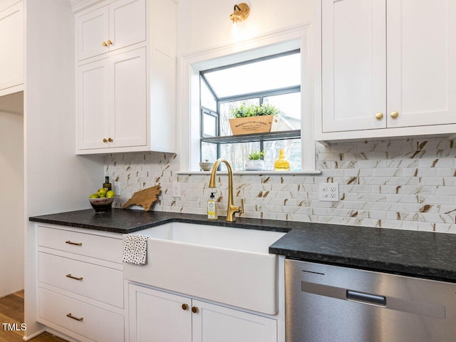 kitchen featuring tasteful backsplash, white cabinetry, dishwasher, wood-type flooring, and sink