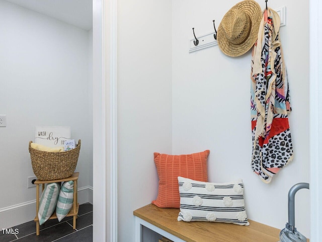 mudroom featuring dark tile patterned flooring