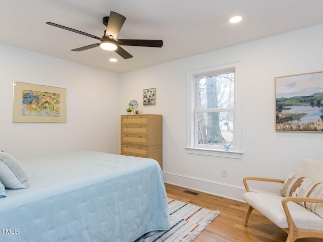 bedroom with hardwood / wood-style flooring and ceiling fan