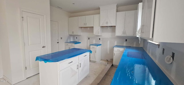 interior space featuring white cabinetry and a center island