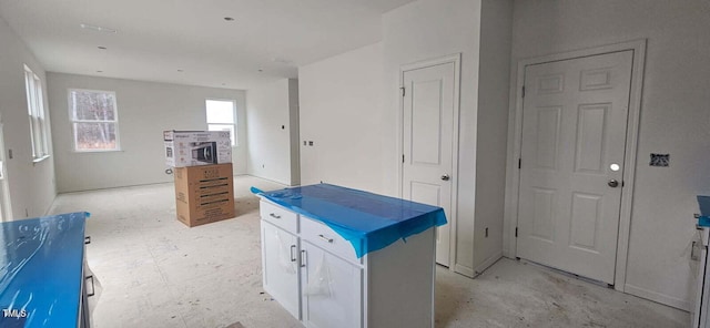 kitchen with a center island and white cabinets