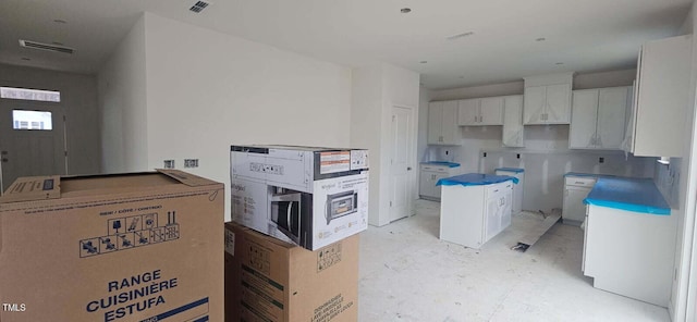 kitchen featuring a center island and white cabinets