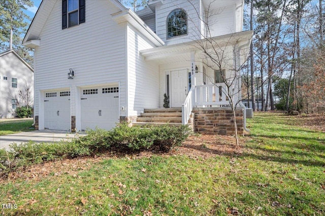 view of front of home with a garage and a front lawn