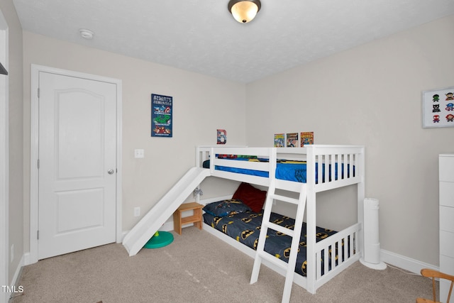 bedroom featuring a textured ceiling and carpet