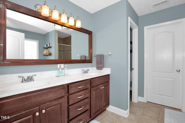 bathroom with vanity and tile patterned flooring