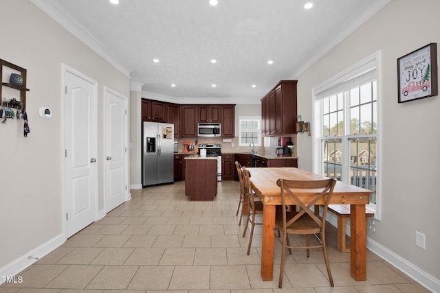 dining room featuring light tile patterned flooring and ornamental molding