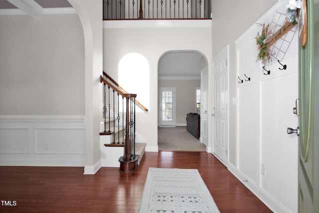 entryway featuring ornamental molding and dark hardwood / wood-style floors