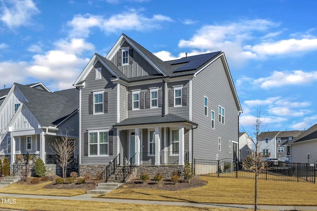 craftsman house with a porch and solar panels