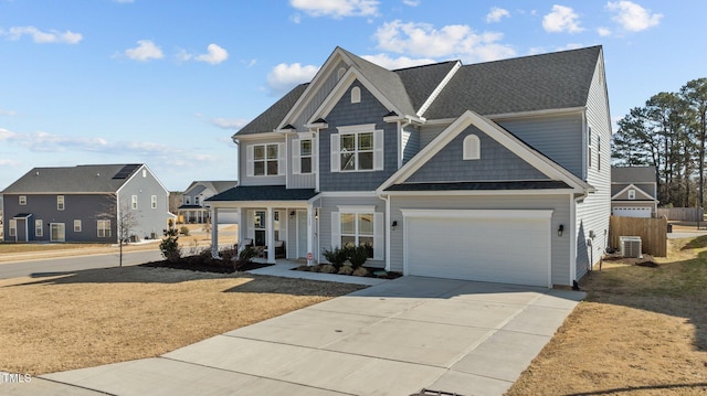 view of front of home with a garage and central AC unit