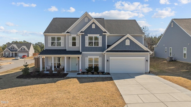 view of front facade featuring a garage, central AC, and covered porch