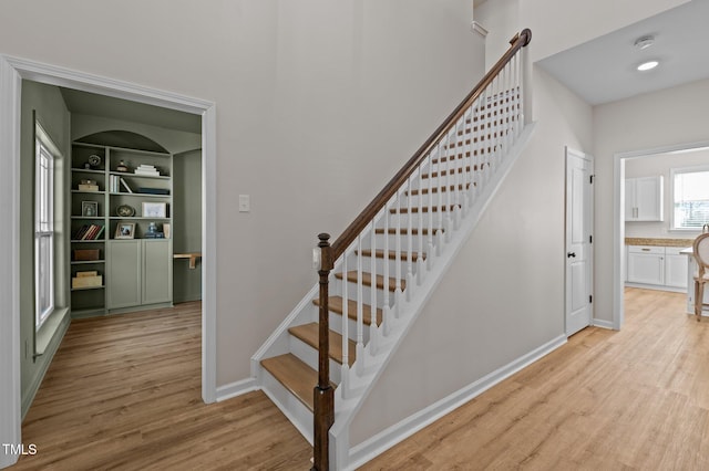 staircase with wood-type flooring