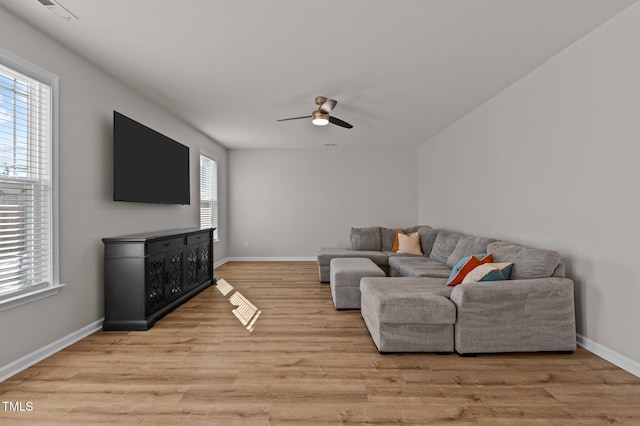 living room with ceiling fan and light hardwood / wood-style floors