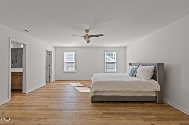 bedroom with ceiling fan, light wood-type flooring, and ensuite bath