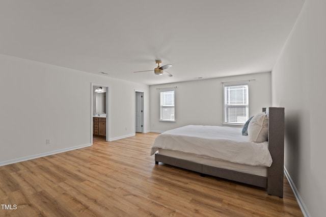 bedroom featuring connected bathroom, light hardwood / wood-style flooring, and ceiling fan