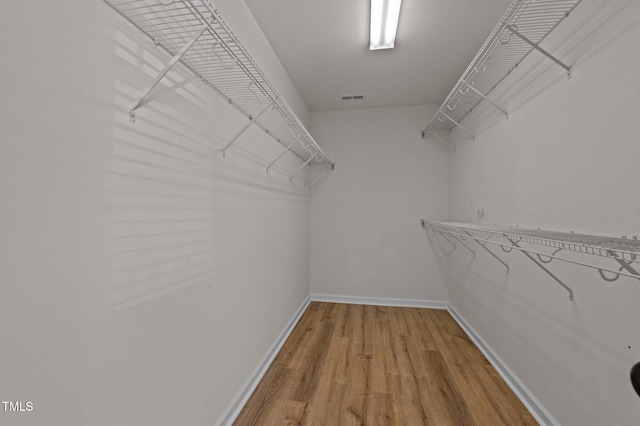 spacious closet featuring hardwood / wood-style flooring