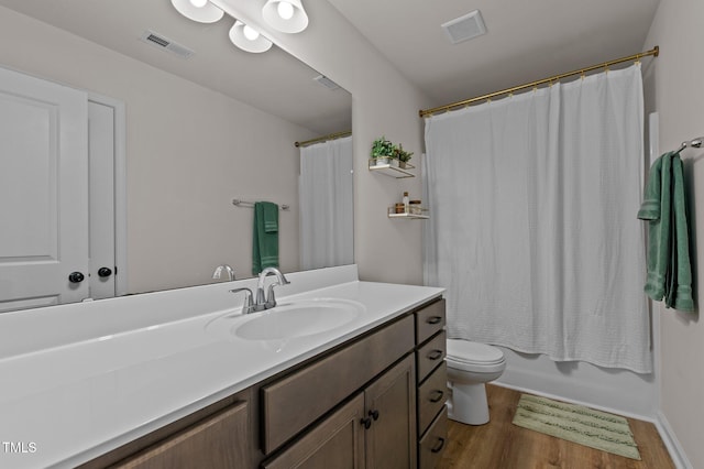 full bathroom featuring vanity, wood-type flooring, shower / bath combination with curtain, and toilet