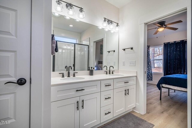 bathroom with vanity, wood-type flooring, ceiling fan, and walk in shower