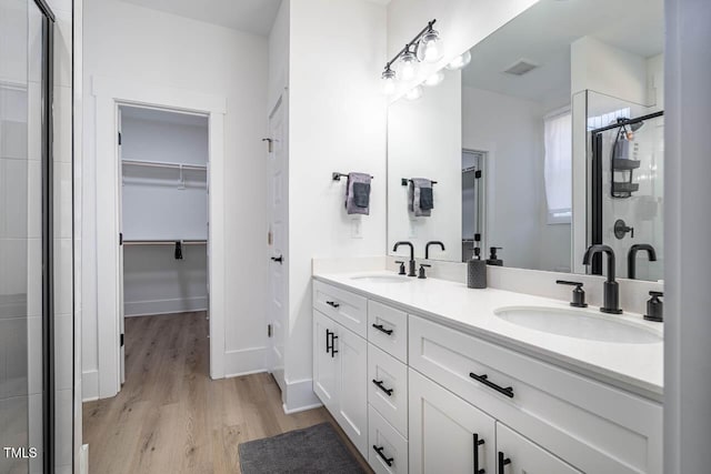 bathroom featuring vanity, hardwood / wood-style floors, and walk in shower