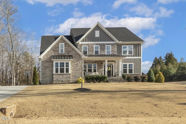 craftsman inspired home with a porch and a front lawn