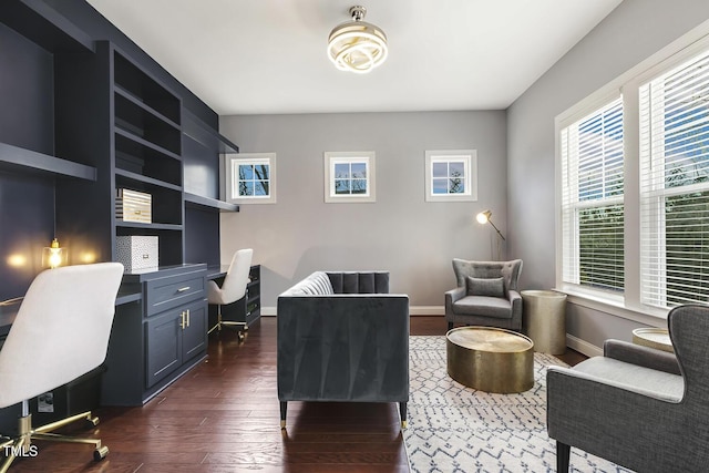 office space with dark hardwood / wood-style floors and built in desk