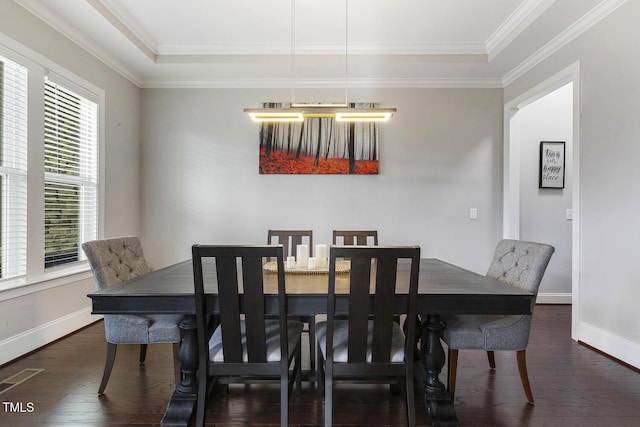 dining room with ornamental molding and dark hardwood / wood-style flooring