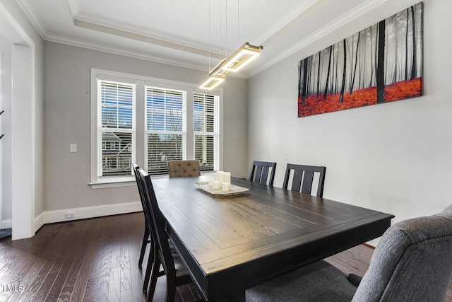 dining space featuring ornamental molding and dark hardwood / wood-style floors