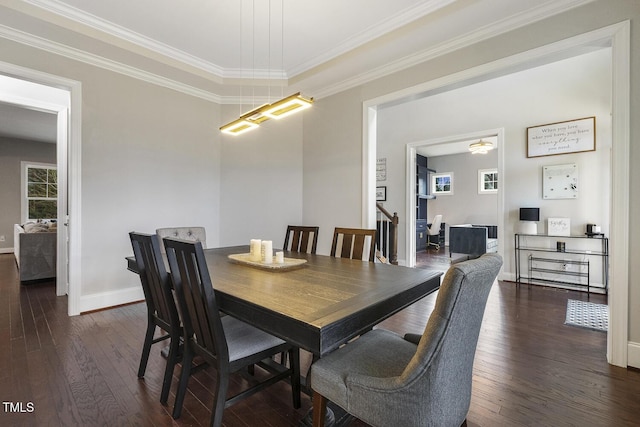 dining area featuring ornamental molding and dark wood-type flooring