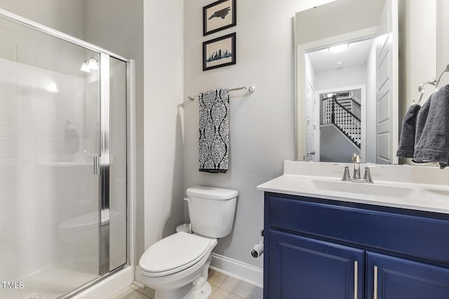 bathroom with walk in shower, vanity, tile patterned floors, and toilet