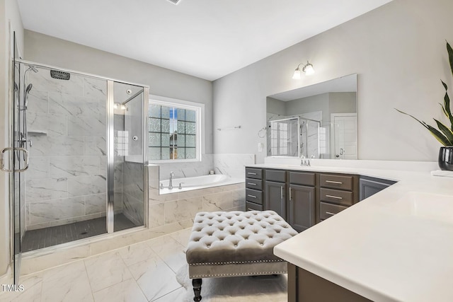 bathroom featuring vanity and independent shower and bath