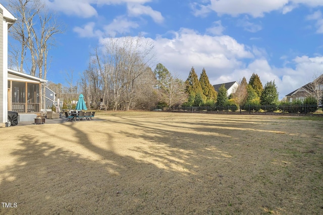 view of yard with a sunroom and a patio area