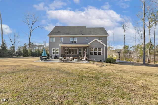 back of house with a patio and a lawn