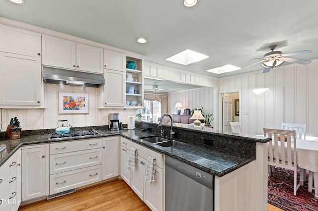 kitchen featuring white cabinetry, appliances with stainless steel finishes, kitchen peninsula, and sink