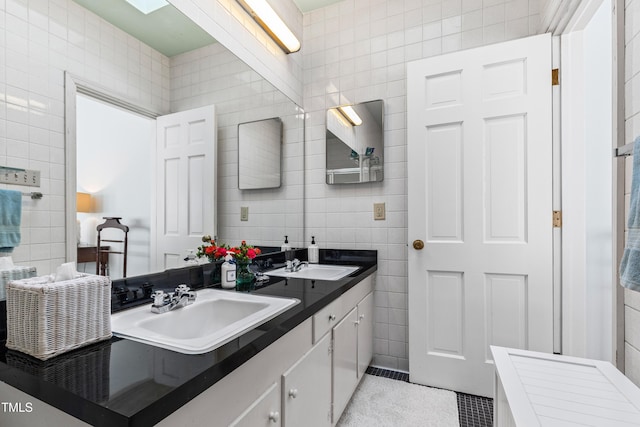 bathroom with vanity, tile patterned flooring, and tile walls