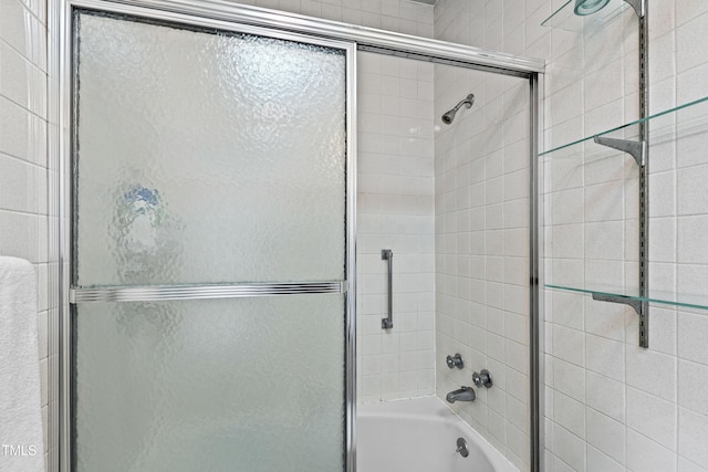 bathroom featuring combined bath / shower with glass door