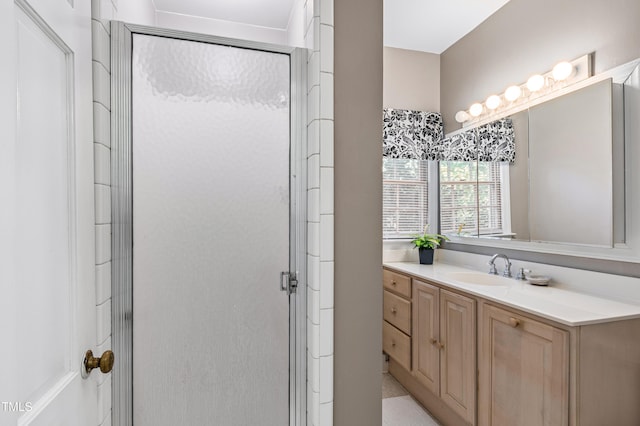 bathroom with walk in shower and vanity