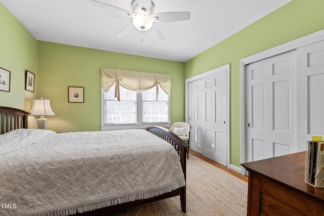 bedroom with multiple closets and ceiling fan