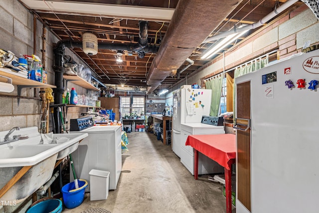 basement featuring white refrigerator and separate washer and dryer