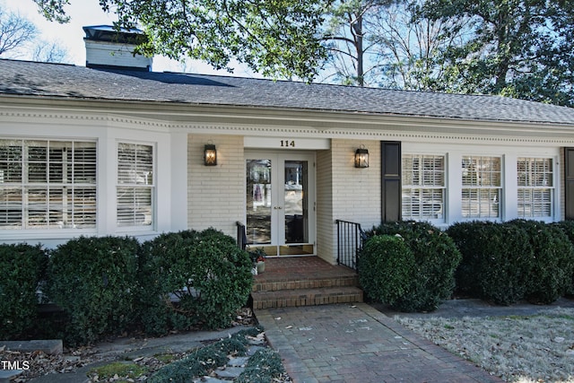 view of exterior entry featuring french doors