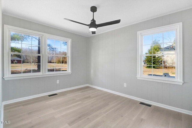 unfurnished room with ornamental molding, ceiling fan, and light wood-type flooring