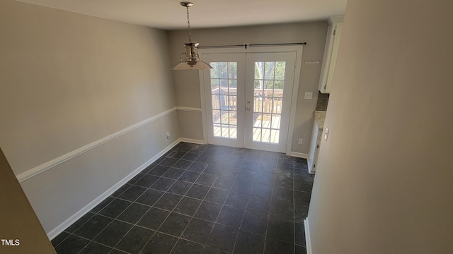 interior space featuring dark tile patterned flooring and french doors