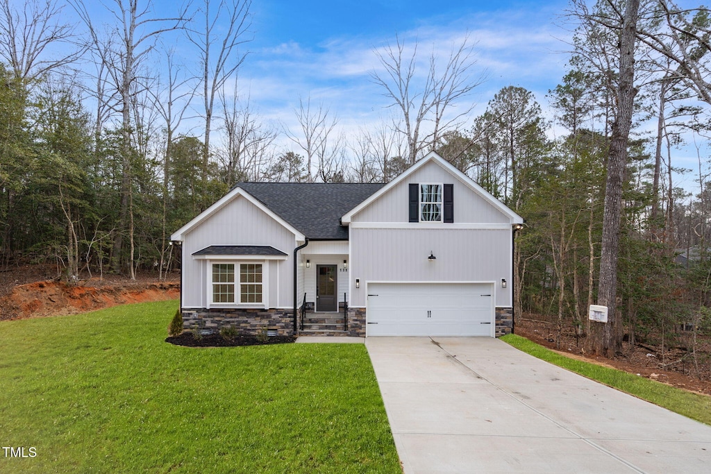 view of front of property featuring a garage and a front yard