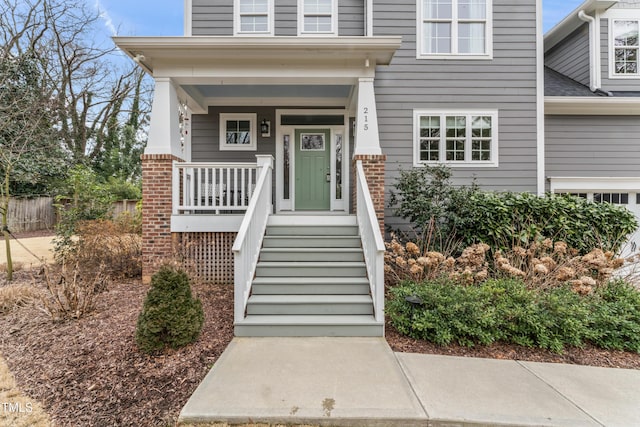 view of exterior entry featuring a porch