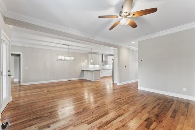 unfurnished living room featuring ornamental molding, light hardwood / wood-style floors, and ceiling fan