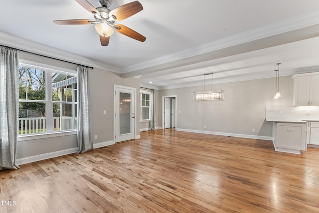 unfurnished living room featuring ceiling fan, ornamental molding, and light hardwood / wood-style floors