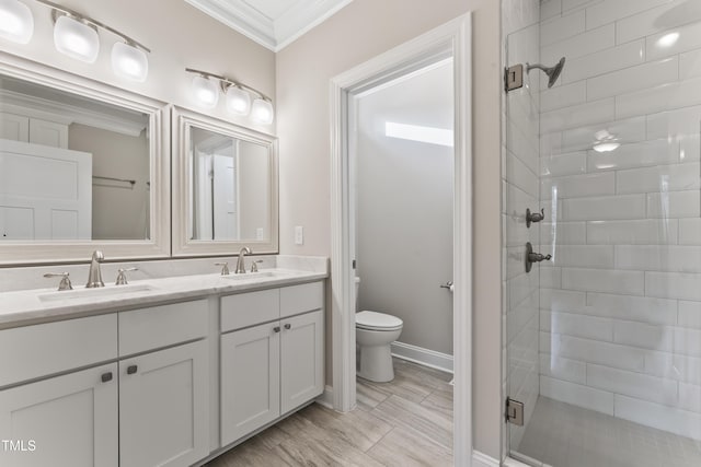 bathroom with ornamental molding, vanity, walk in shower, and toilet